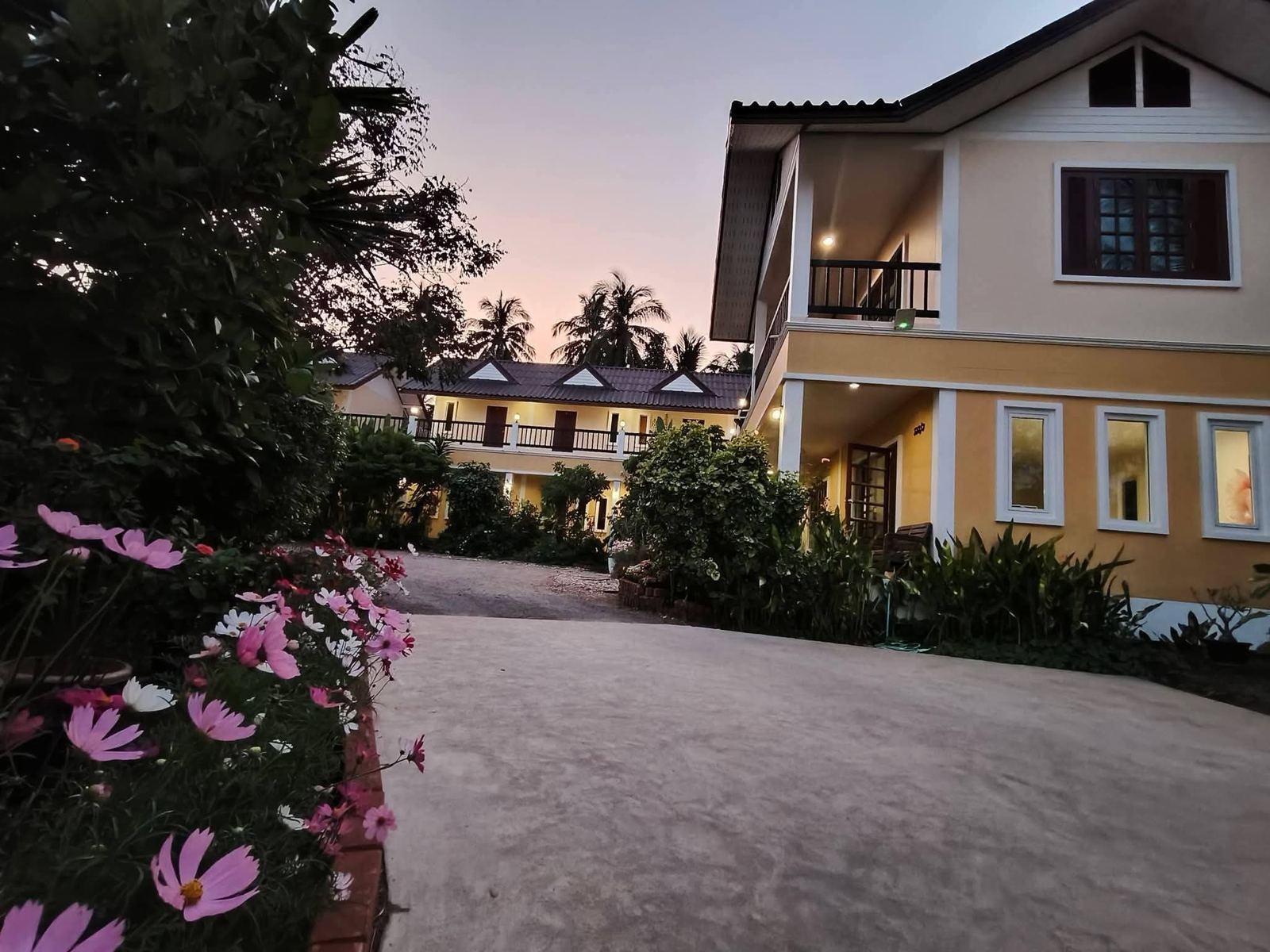The resort buildings at dusk with flowers in front