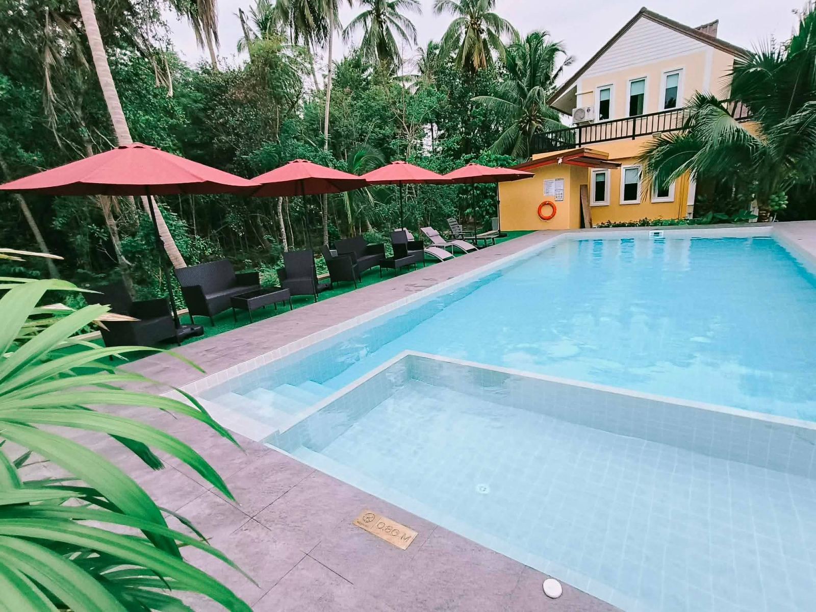 Pool with red umbrellas and lounge chairs