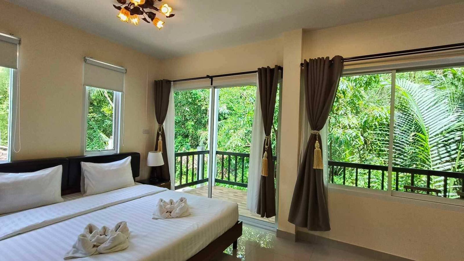 Deluxe room with king bed and glass doors to a balcony